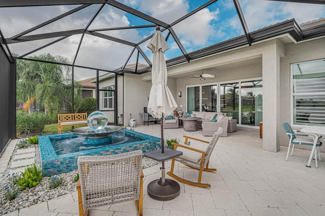 view of patio / terrace featuring ceiling fan, glass enclosure, and outdoor lounge area