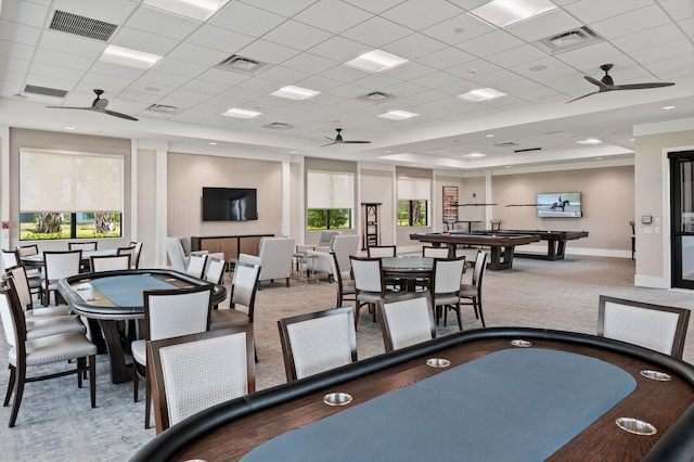 dining space featuring light carpet, a paneled ceiling, and ceiling fan