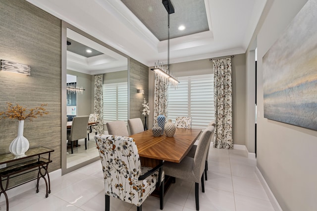 dining room featuring a raised ceiling and light tile patterned floors