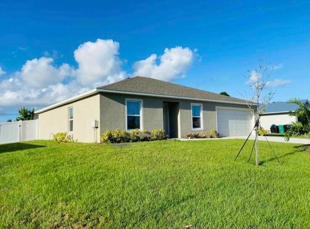 ranch-style home with a garage and a front lawn