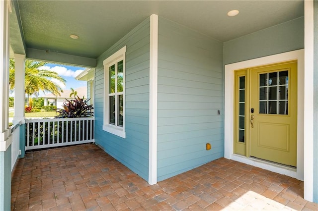 entrance to property featuring a porch