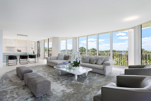 living room with expansive windows and an inviting chandelier