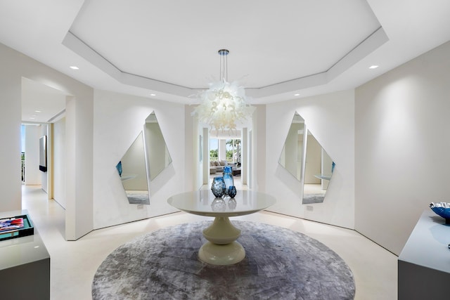 interior space with a tray ceiling and an inviting chandelier