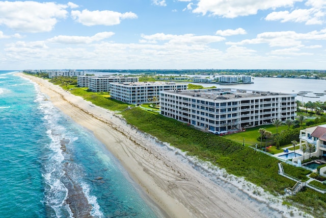 drone / aerial view featuring a water view and a view of the beach