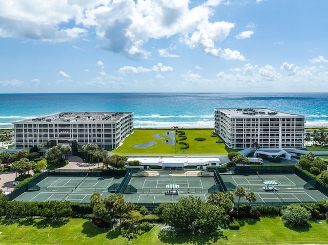 birds eye view of property with a water view and a beach view