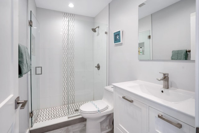 full bath featuring toilet, a stall shower, and vanity