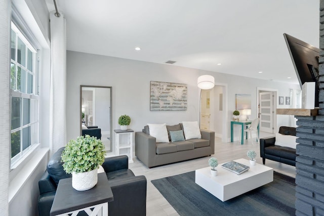 living area with recessed lighting and wood finished floors