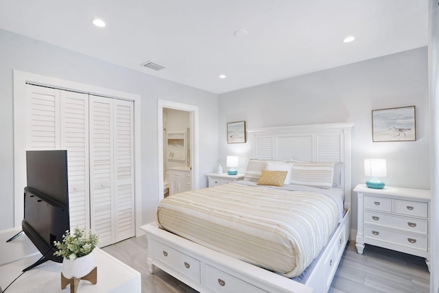 bedroom featuring ensuite bathroom, light wood-style flooring, a closet, visible vents, and recessed lighting