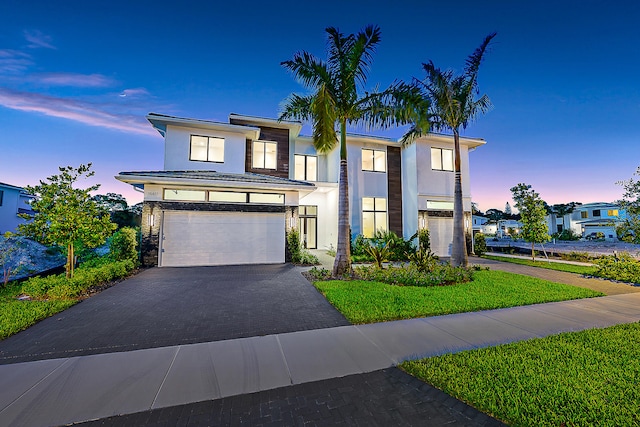 view of front of house featuring a yard and a garage