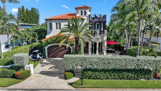 mediterranean / spanish house with a garage and a balcony