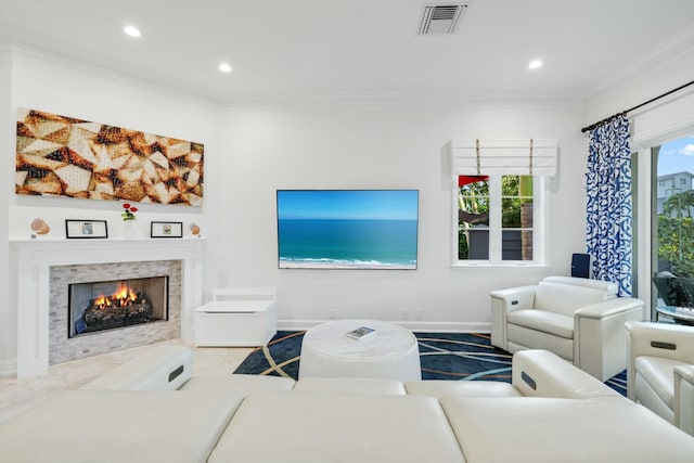 carpeted living room with a tiled fireplace and ornamental molding