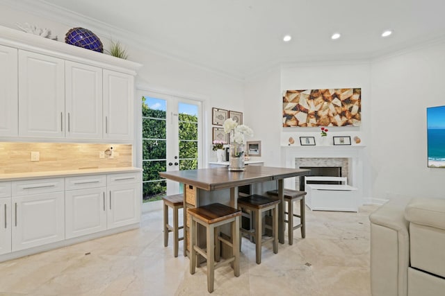 dining area featuring crown molding and french doors