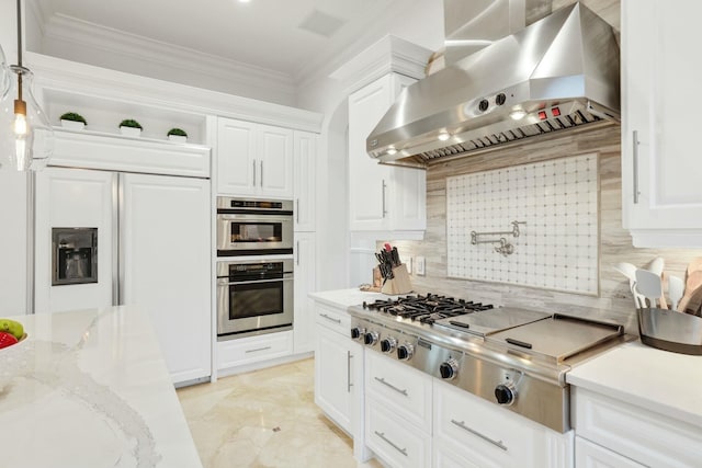 kitchen with backsplash, white cabinets, wall chimney exhaust hood, and stainless steel appliances