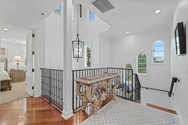 hall featuring crown molding and hardwood / wood-style flooring