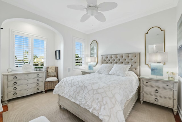 carpeted bedroom featuring multiple windows, ceiling fan, and ornamental molding