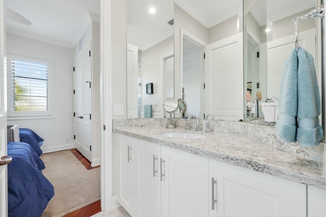 bathroom with crown molding and vanity