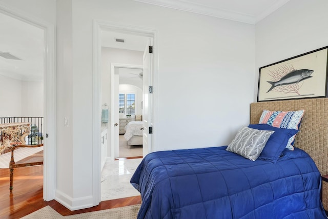 bedroom featuring hardwood / wood-style flooring and ornamental molding