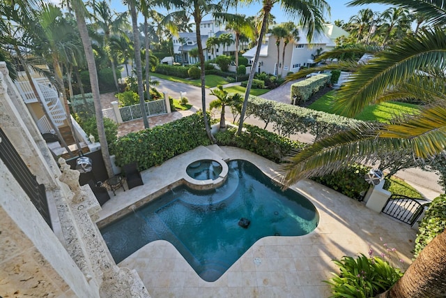 view of swimming pool featuring an in ground hot tub