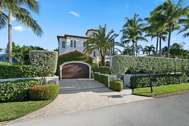 mediterranean / spanish house featuring a garage