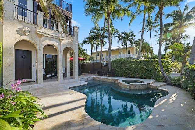 view of pool with an in ground hot tub and a patio