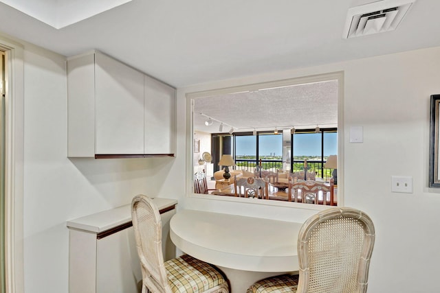 dining room featuring rail lighting