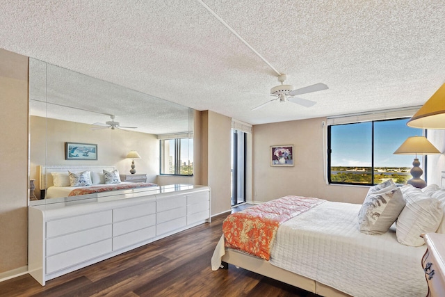 bedroom featuring a textured ceiling, ceiling fan, and dark wood-type flooring