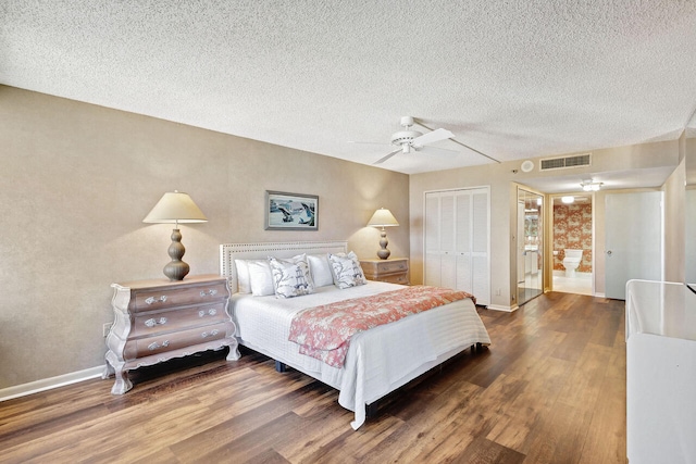 bedroom with ceiling fan, a textured ceiling, a closet, and dark hardwood / wood-style floors