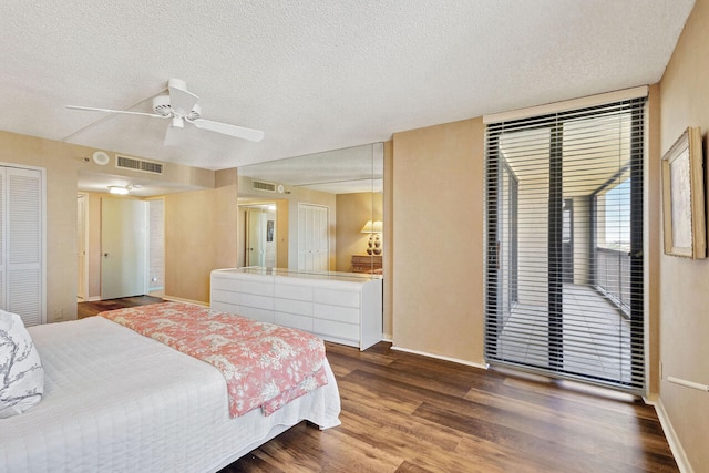 bedroom featuring access to exterior, a textured ceiling, a closet, ceiling fan, and hardwood / wood-style flooring