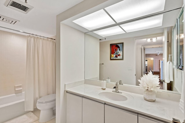 full bathroom featuring shower / tub combo with curtain, tile patterned floors, vanity, and toilet