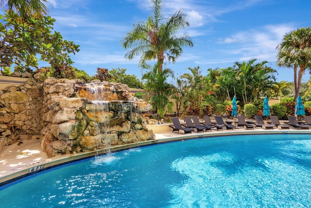 view of swimming pool with pool water feature