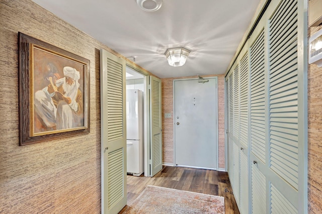 corridor with hardwood / wood-style floors