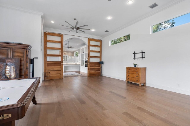 interior space with wood-type flooring, ceiling fan, and a healthy amount of sunlight