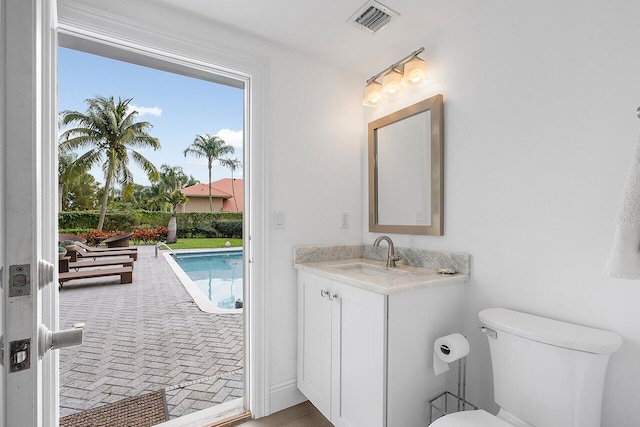 bathroom featuring vanity and toilet