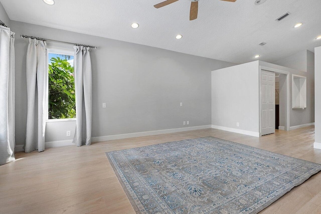 unfurnished room with light hardwood / wood-style flooring, ceiling fan, and a textured ceiling