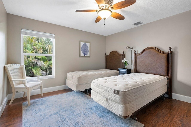 bedroom with dark wood-type flooring and ceiling fan