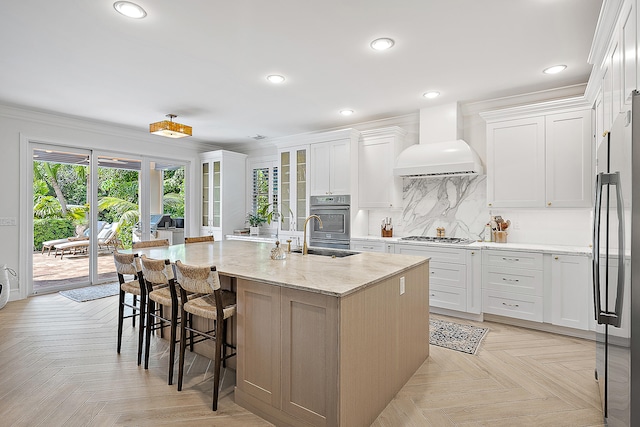 kitchen featuring premium range hood, white cabinetry, light parquet floors, and stainless steel appliances