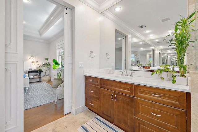 bathroom featuring tile patterned flooring, vanity, and ornamental molding