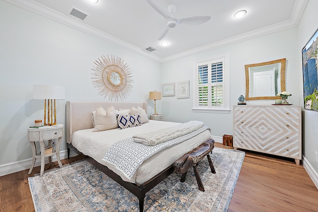 bedroom with ceiling fan, crown molding, and wood-type flooring