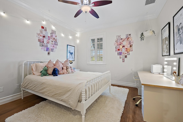 bedroom featuring ceiling fan, crown molding, and dark wood-type flooring