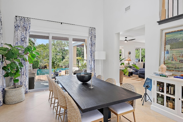 dining room with ceiling fan, a healthy amount of sunlight, and light tile patterned flooring