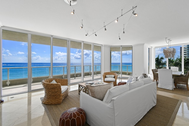 tiled living room with a wall of windows and a water view