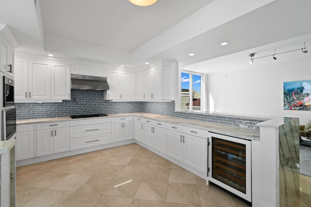 kitchen with white cabinetry, wine cooler, light stone counters, black appliances, and range hood