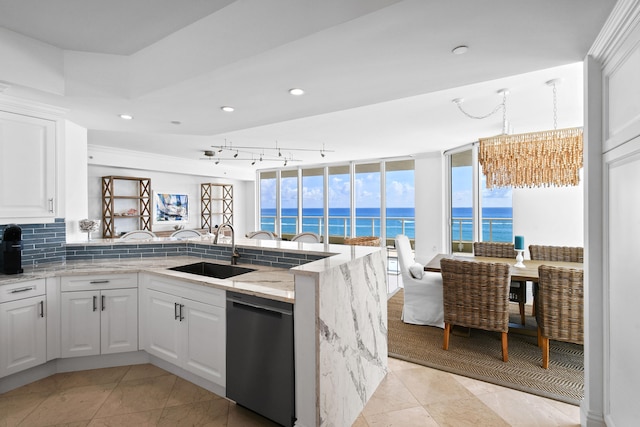 kitchen with dishwasher, sink, kitchen peninsula, and white cabinetry