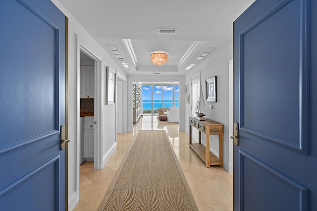 hallway featuring a tray ceiling