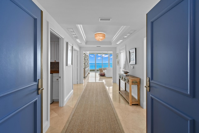5050 N Ocean Dr Unit 402, Singer Island, FL 33404 - corridor featuring a raised ceiling and baseboards