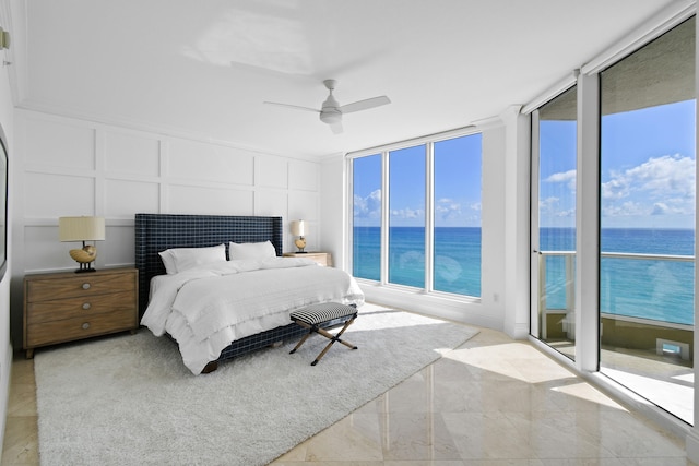 bedroom with a water view, floor to ceiling windows, and ceiling fan