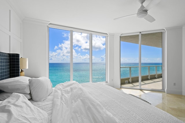 bedroom featuring multiple windows, a water view, and access to exterior