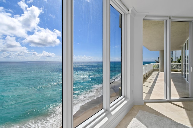 5050 N Ocean Dr Unit 402, Singer Island, FL 33404 - unfurnished sunroom with view of water and beach