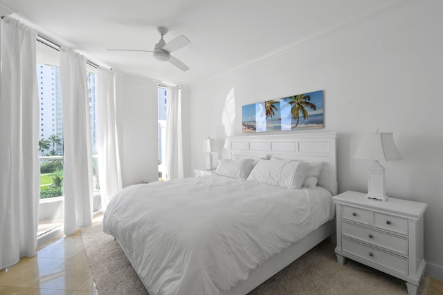 bedroom with multiple windows, light tile patterned floors, ornamental molding, and ceiling fan