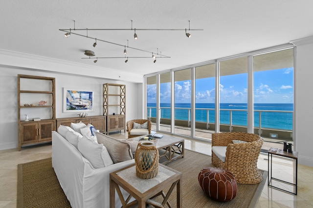 living room with a wall of windows and a water view